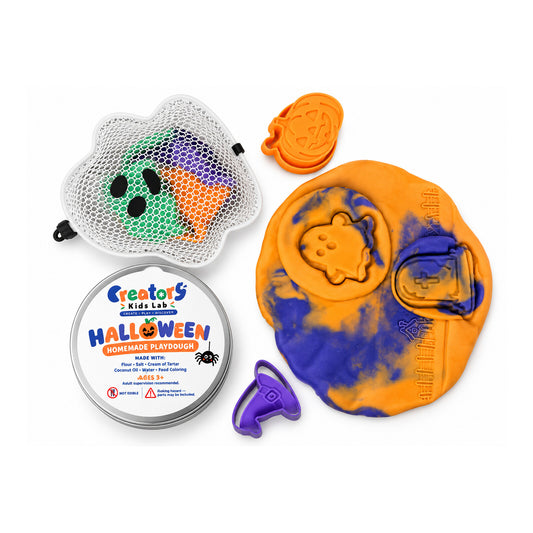 Halloween sensory dough with impressions beside its tools and storage container