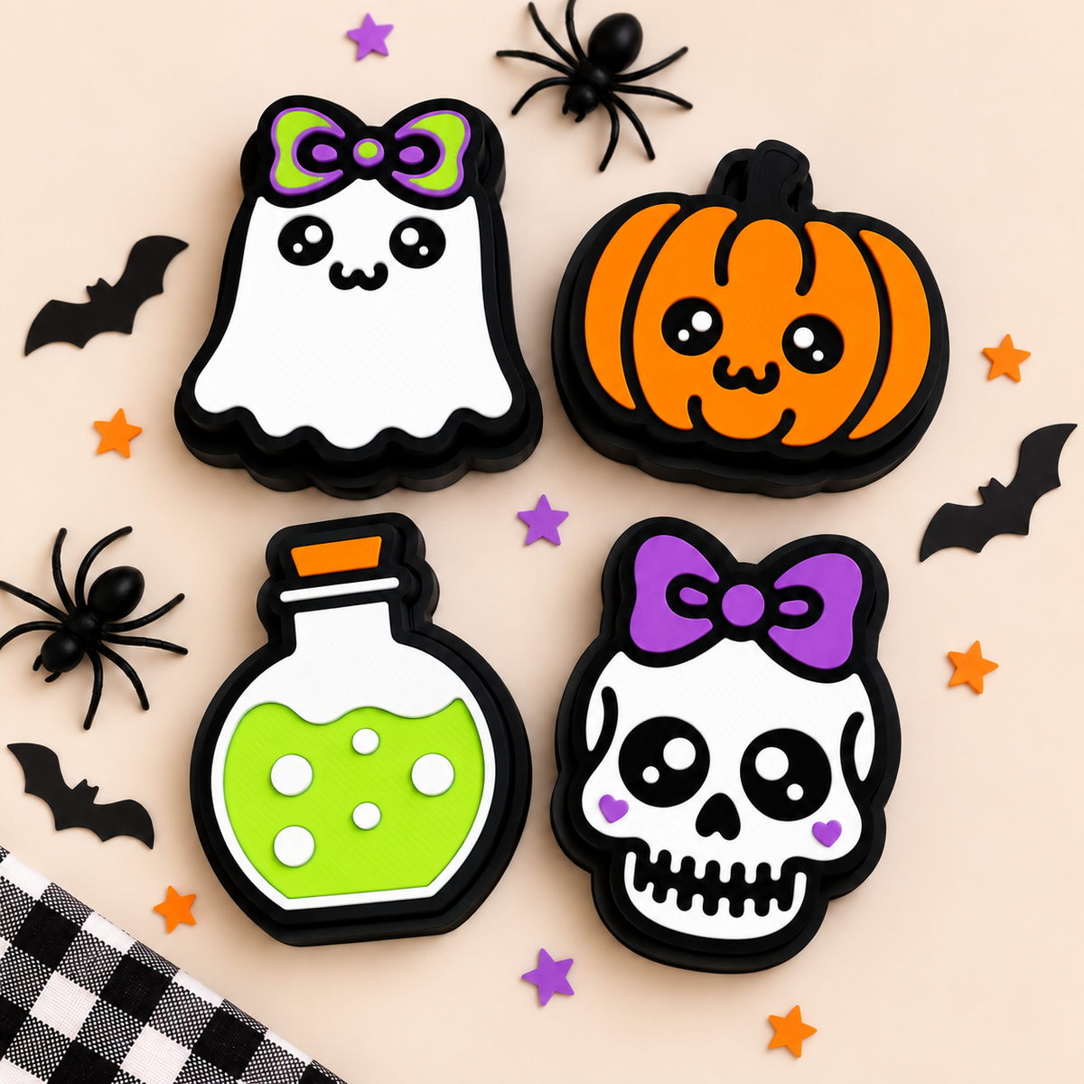 Four Halloween clicker designs displayed together with seasonal decorations