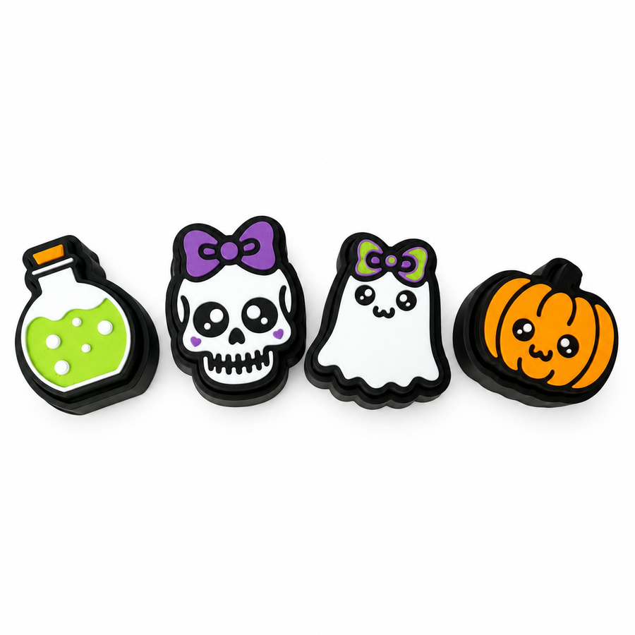 Four Halloween fidget clickers arranged in a row on white