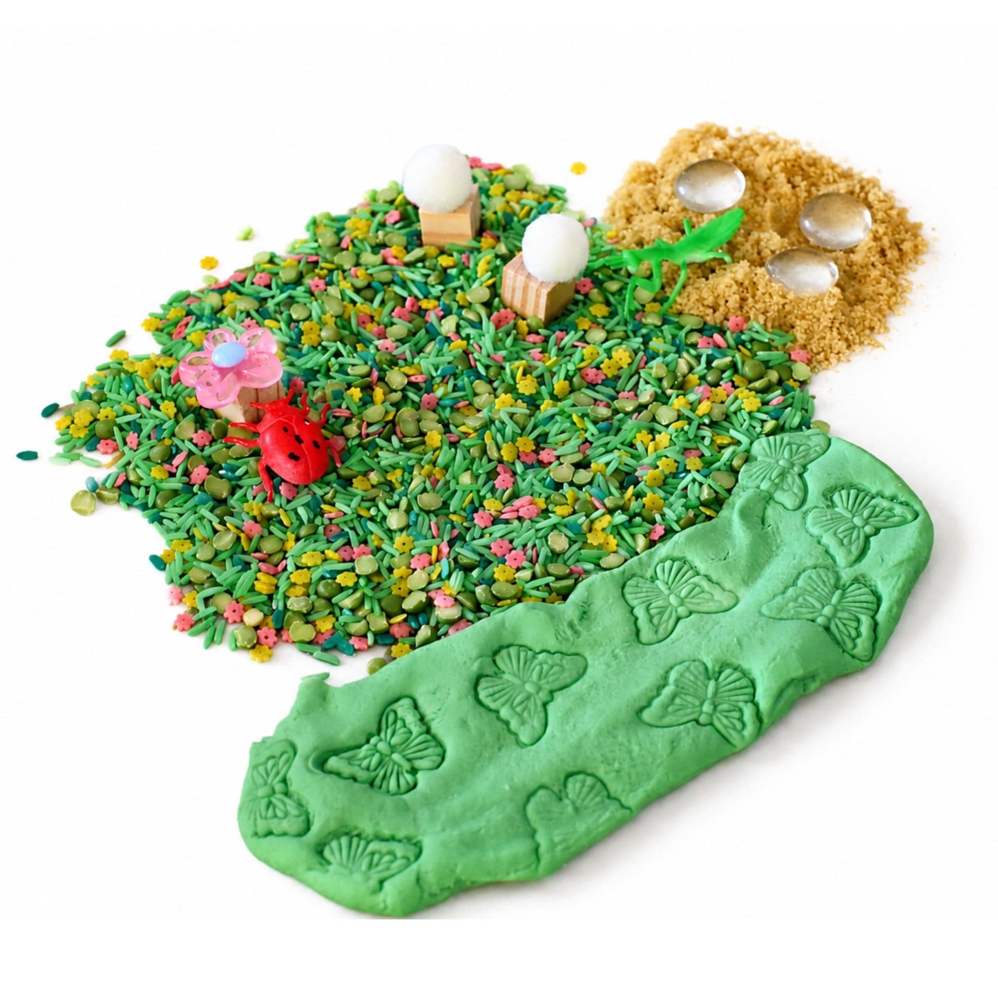 Toddler exploring bug sensory bin with scoops and molds