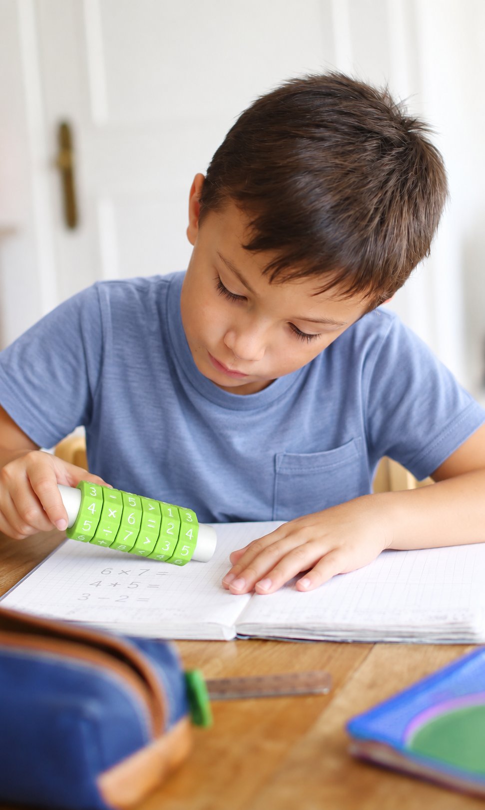 Child holding Spin and Solve while working in a notebook