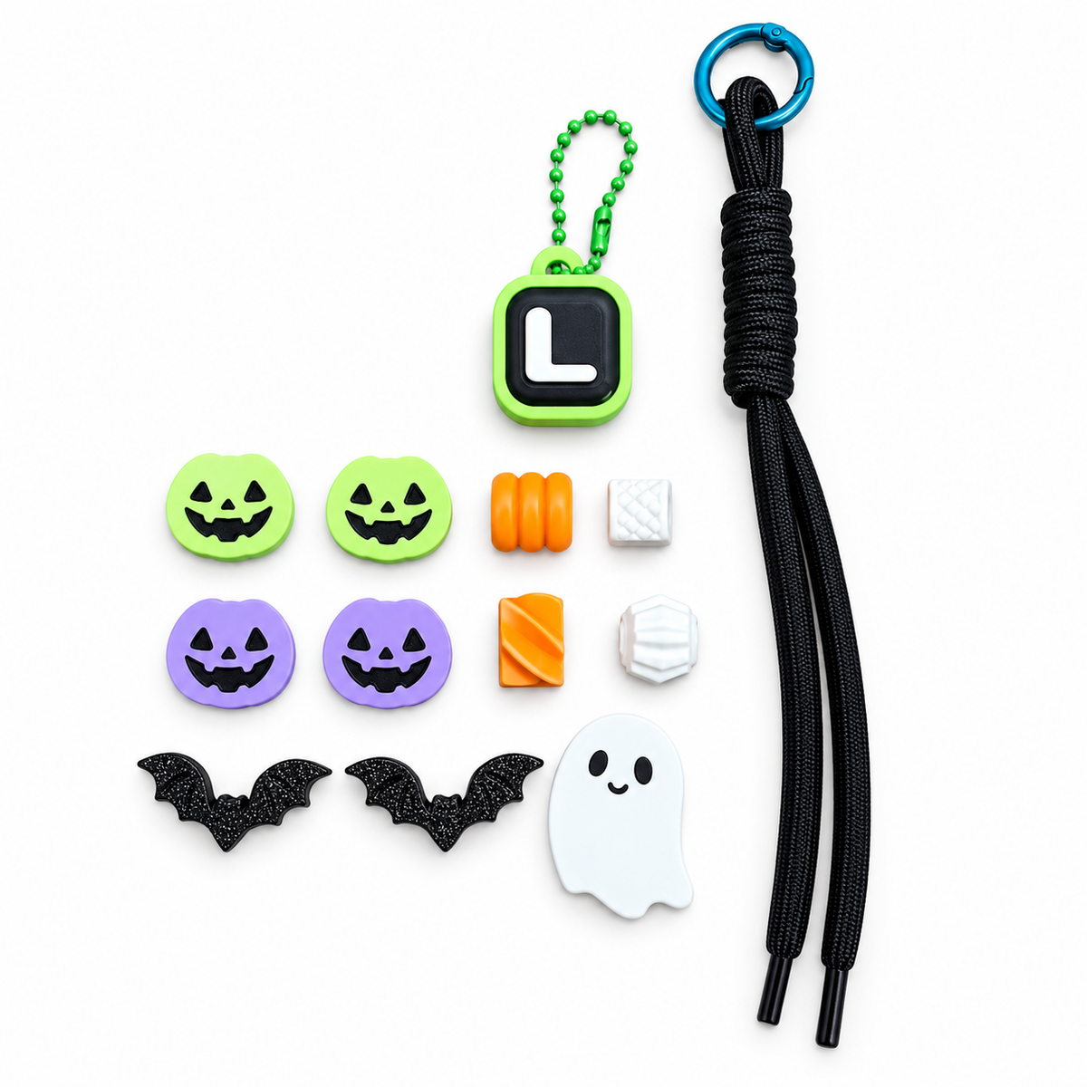 Unassembled Boo & You keychain components with black cord, example L initial clicker, Halloween pumpkins, bats, ghost and textured beads.