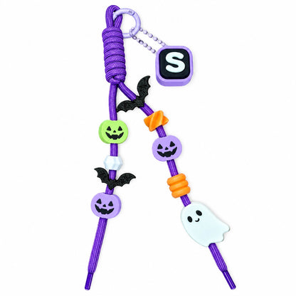Assembled Boo & You Halloween keychain inspiration with purple cord, example S initial clicker, pumpkins, bats and a smiling ghost.