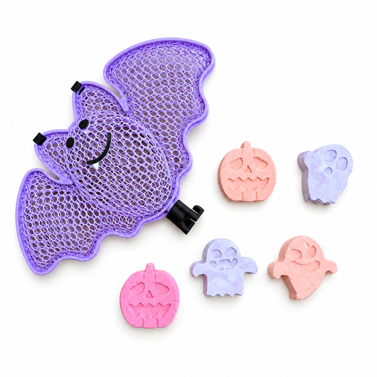 Purple bat-shaped case beside five colorful Halloween chalk pieces