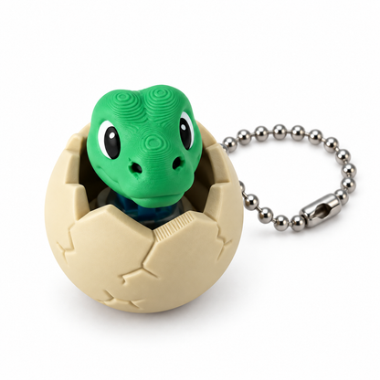 Front view of the Little Hatchling Dino Clicker and silver ball chain