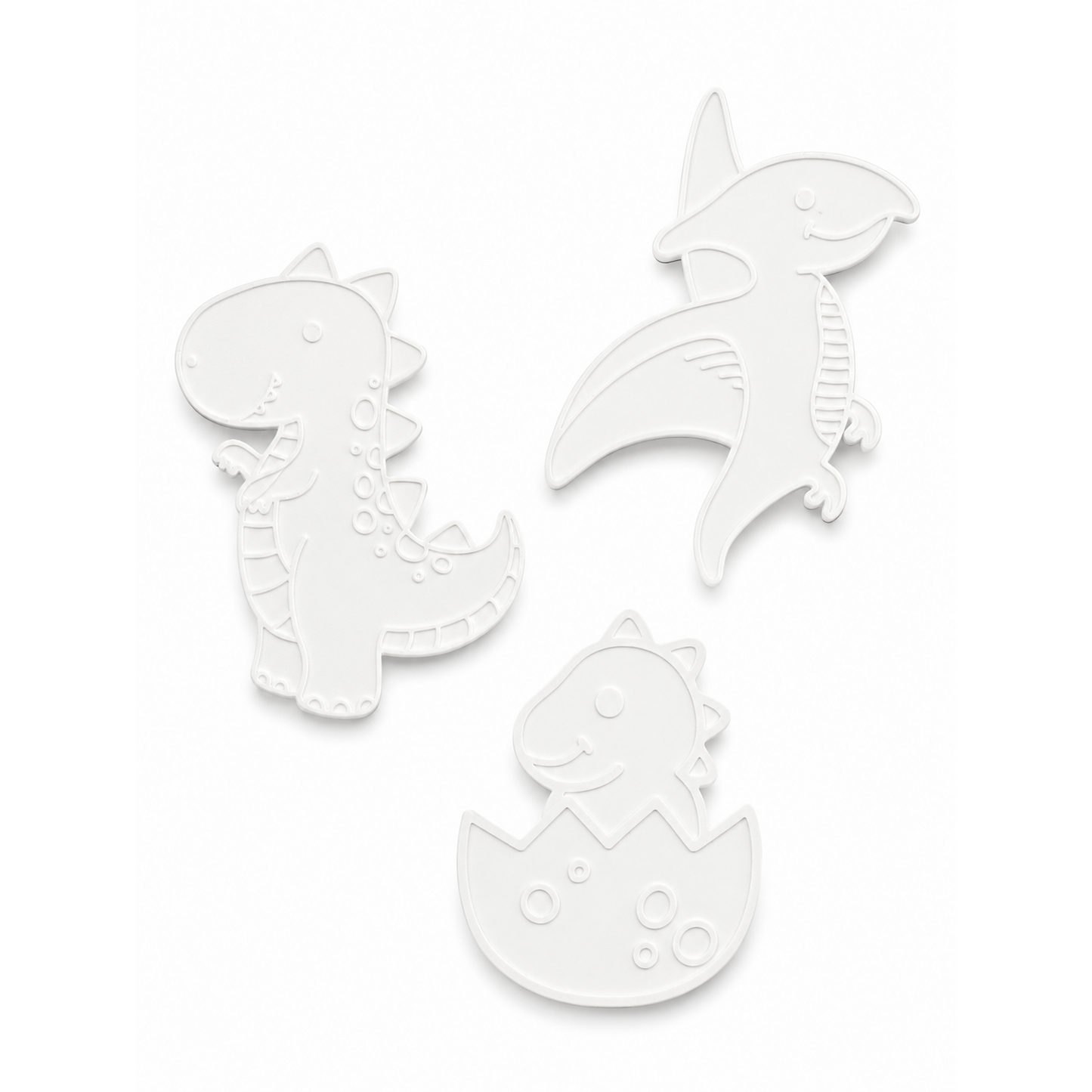 The three unpainted 3D dinosaur figures included in the kit