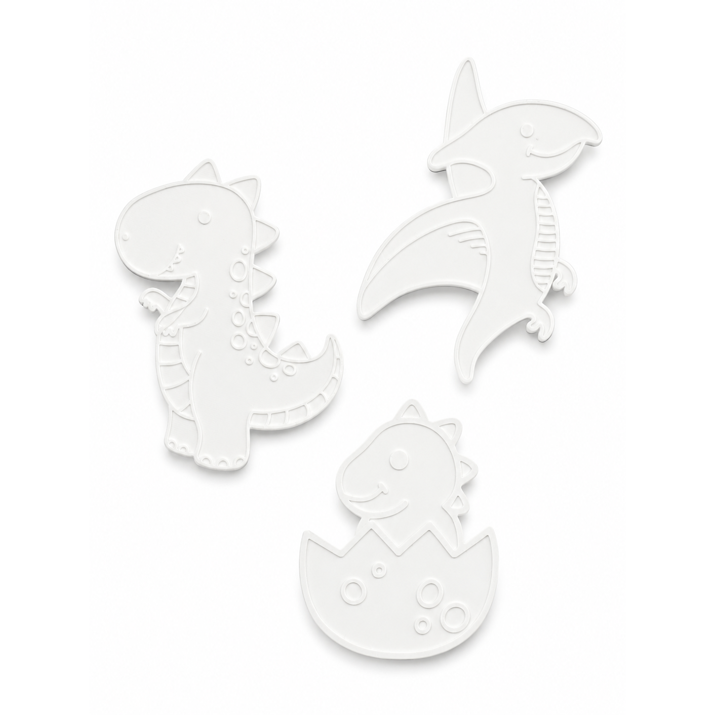 The three unpainted 3D dinosaur figures included in the kit