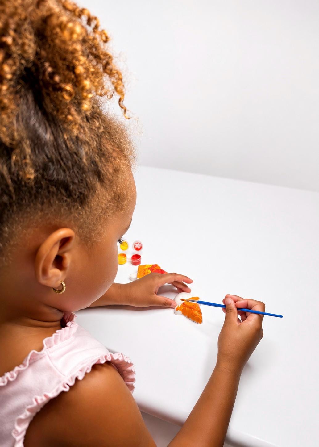 Child painting ice cream plaster figure