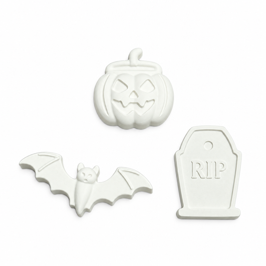jack-o'-lantern and bat and tombstone with RIP lettering in unpainted plaster on a white background