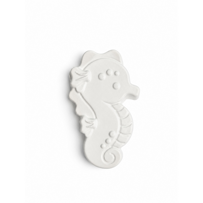 seahorse in unpainted plaster on a white background